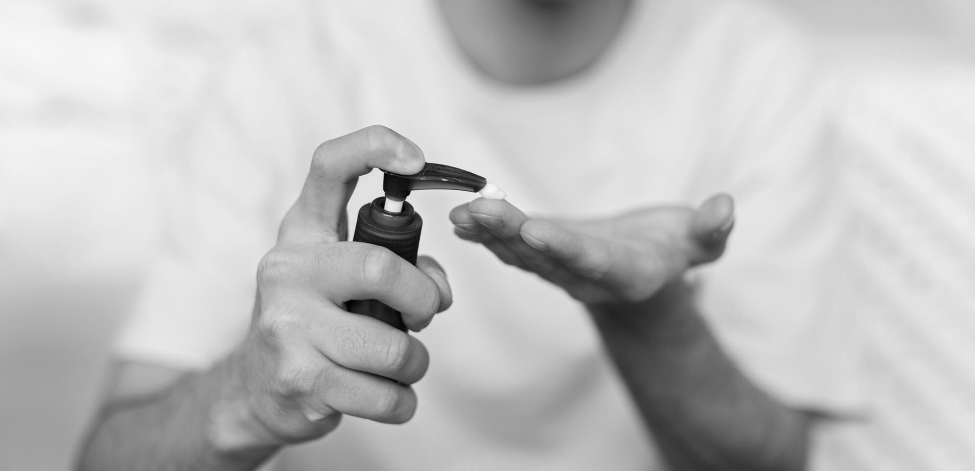 Man using oil based lubricant with a pump bottle.