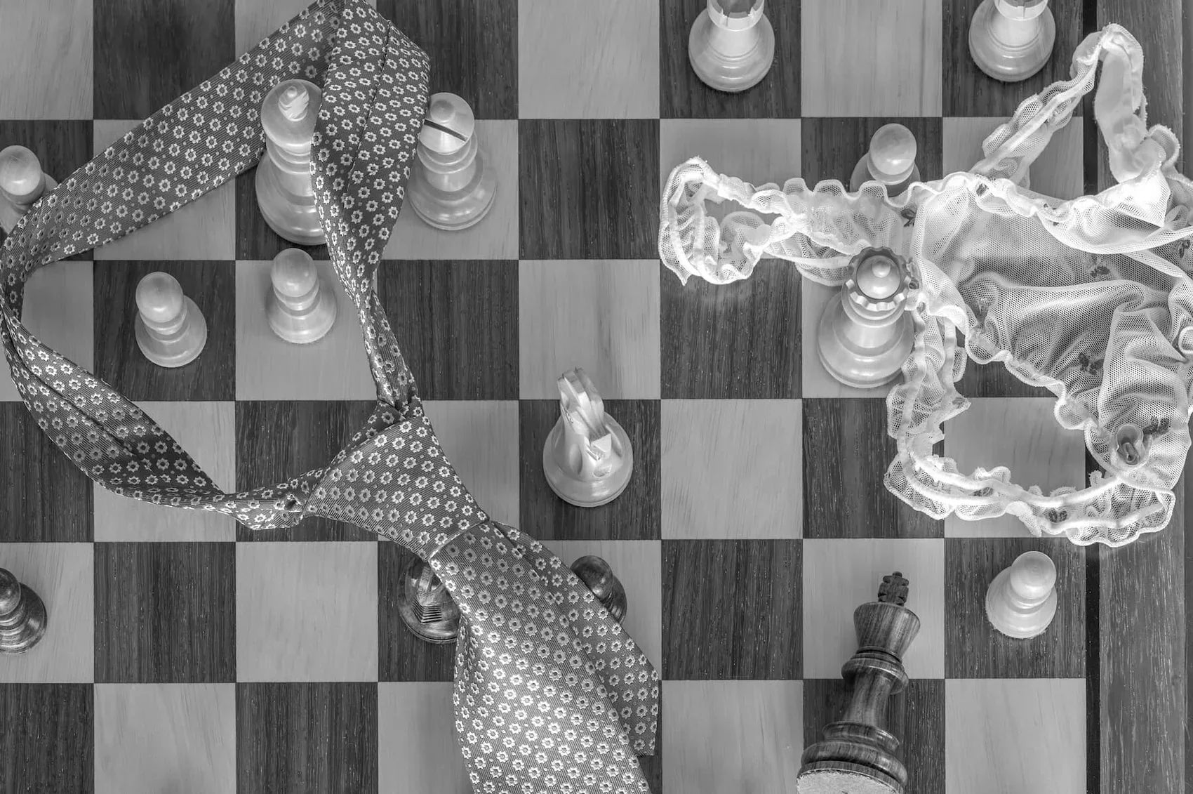 Chess board with tie and panty involving sexy adult games.