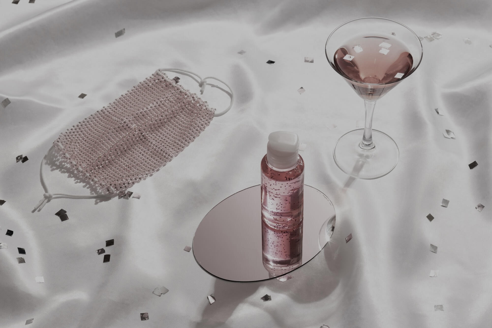 Bottle of a flavored lube and edible lube with a pink martini.