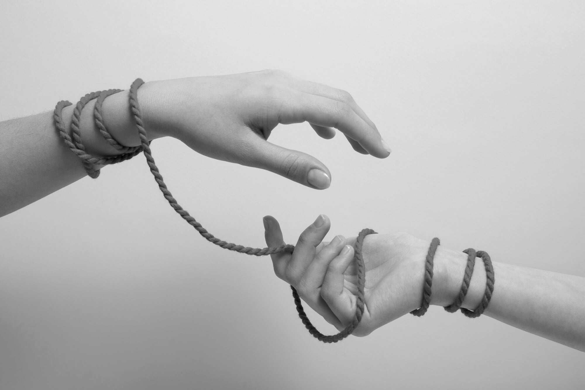 Woman hands tied with a jute sex rope.
