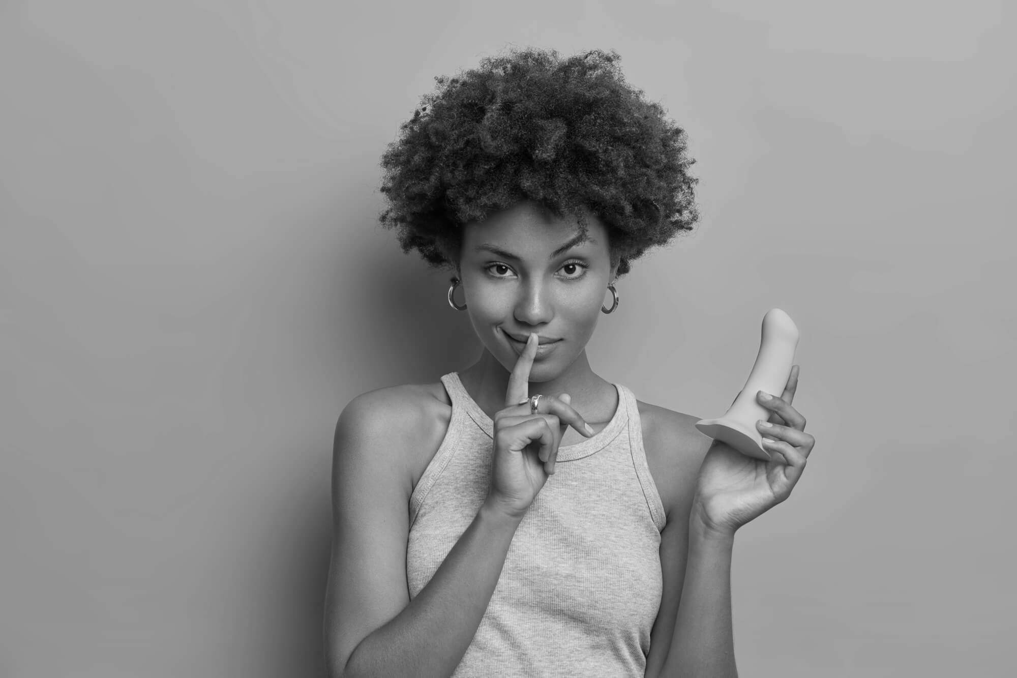 Woman holding in her hand an inflatable dildo