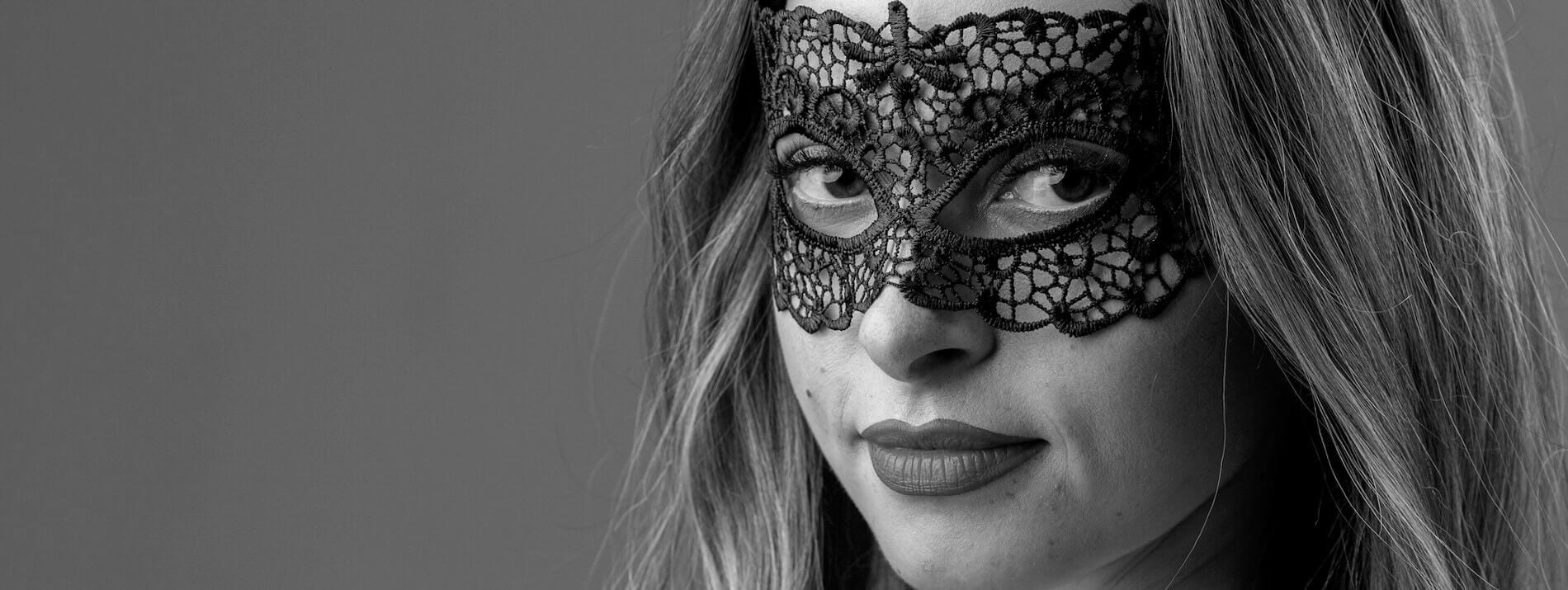 Woman with mask promoting sexy halloween costume