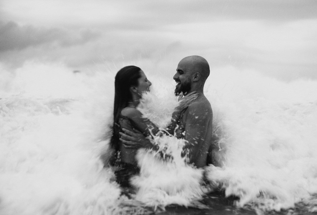 Man and woman in waves in water