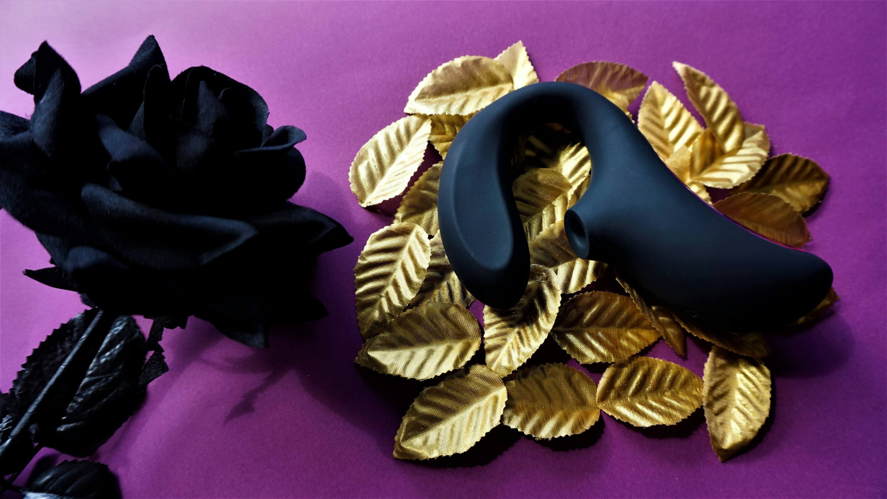 Luxury-themed composition featuring a wireless G-spot vibrator, black rose, and gold leaves—highlighting the growing trend of intimate wellness.