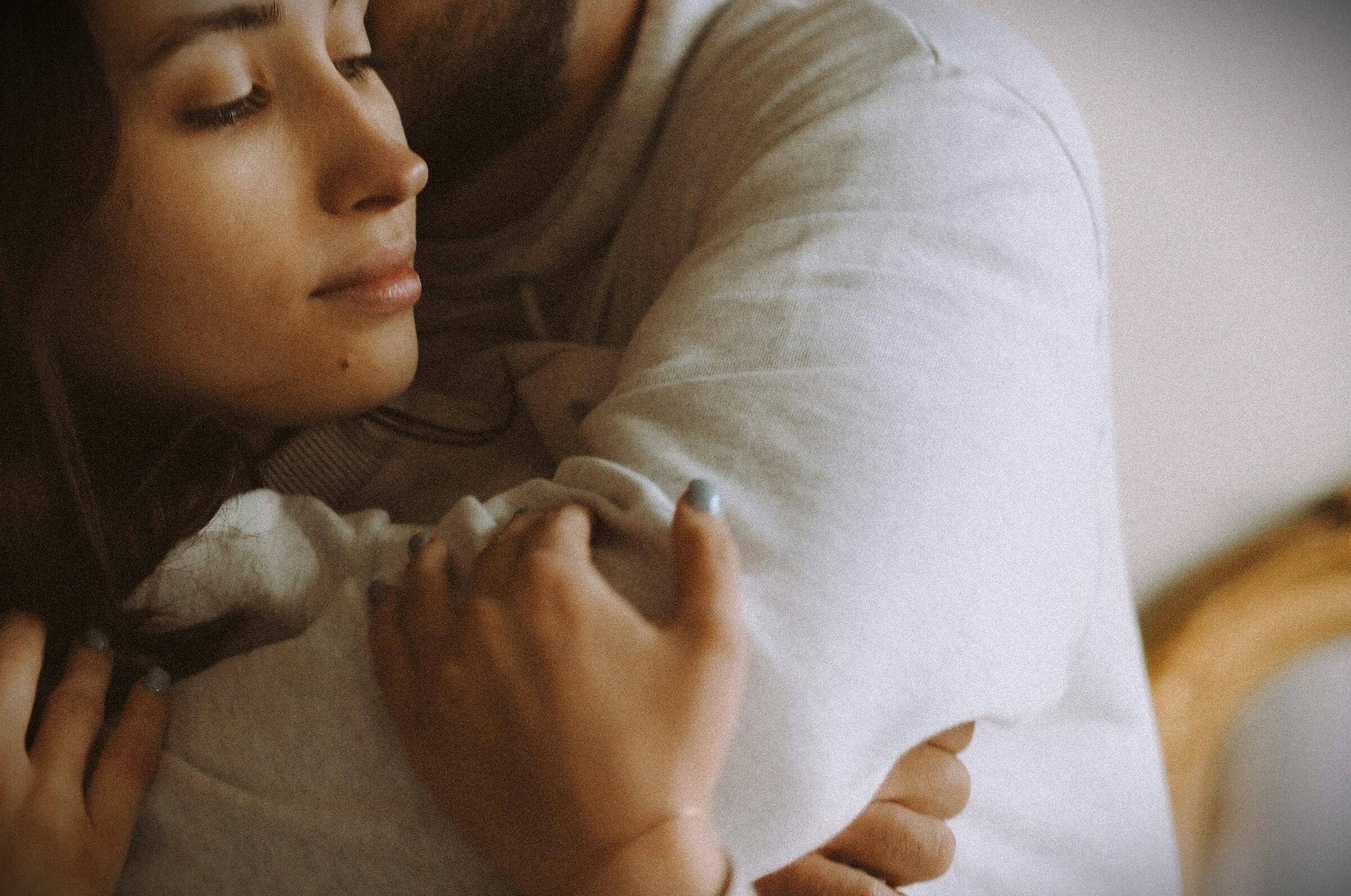 Close-up of a couple embracing gently, symbolizing trust, emotional safety, and open communication in anal play consent and intimate exploration.