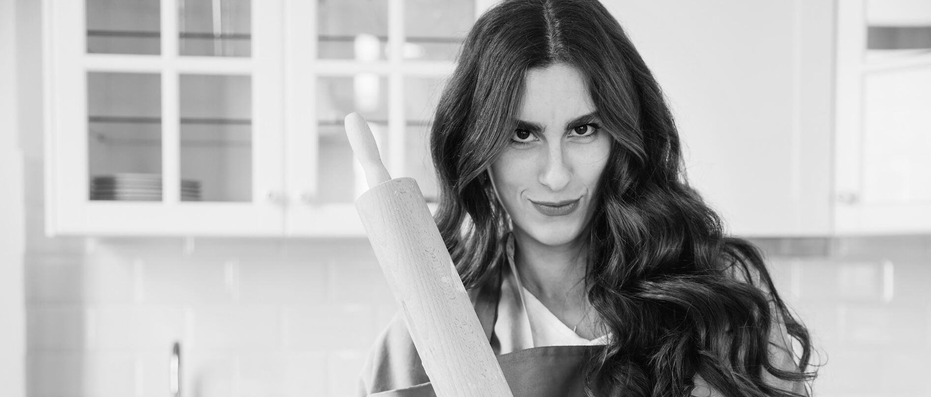 Woman in the kitchen with a dough roller wearing sexy maid costume and sexy French Maid costume