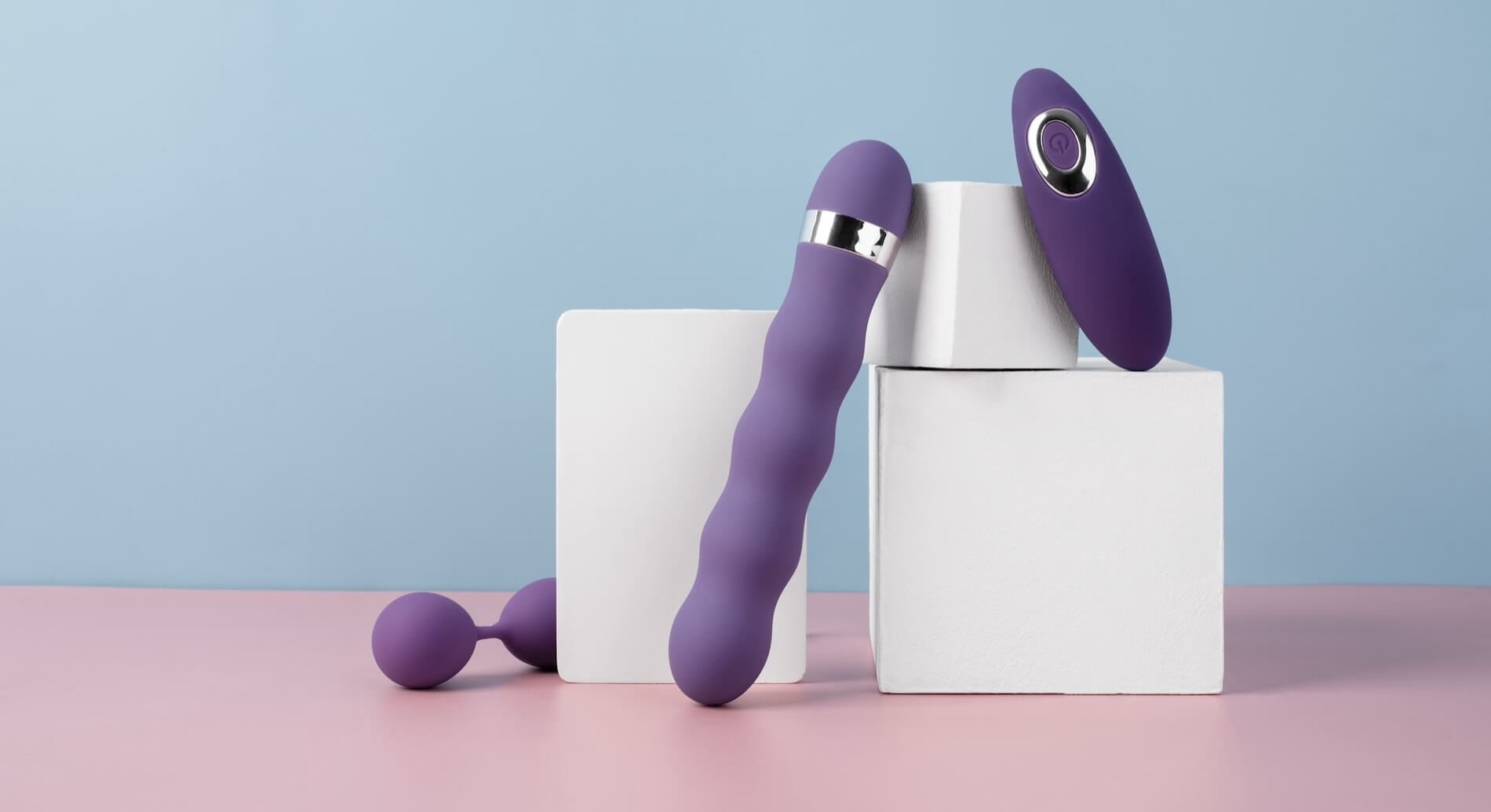 Remote control vibrator and remote control sex toy with remote on a pink and blue background.