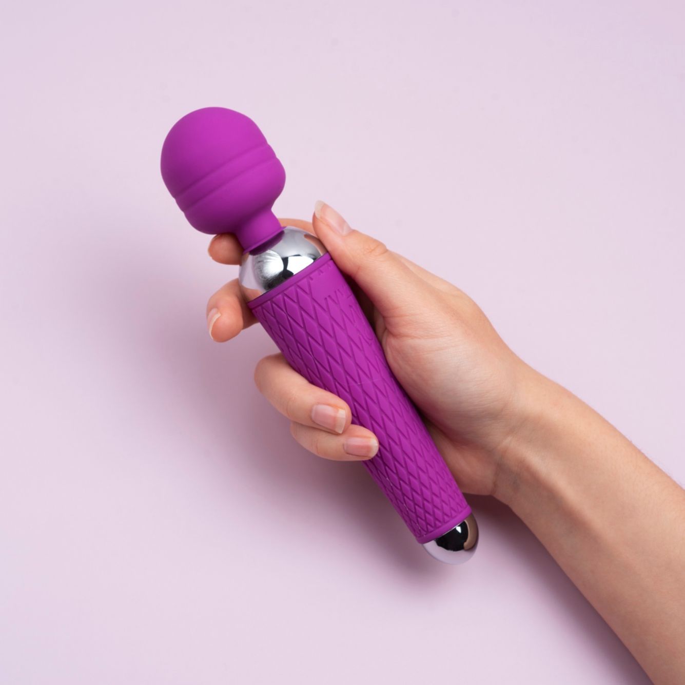 Purple and chrome wand massager in a woman hand